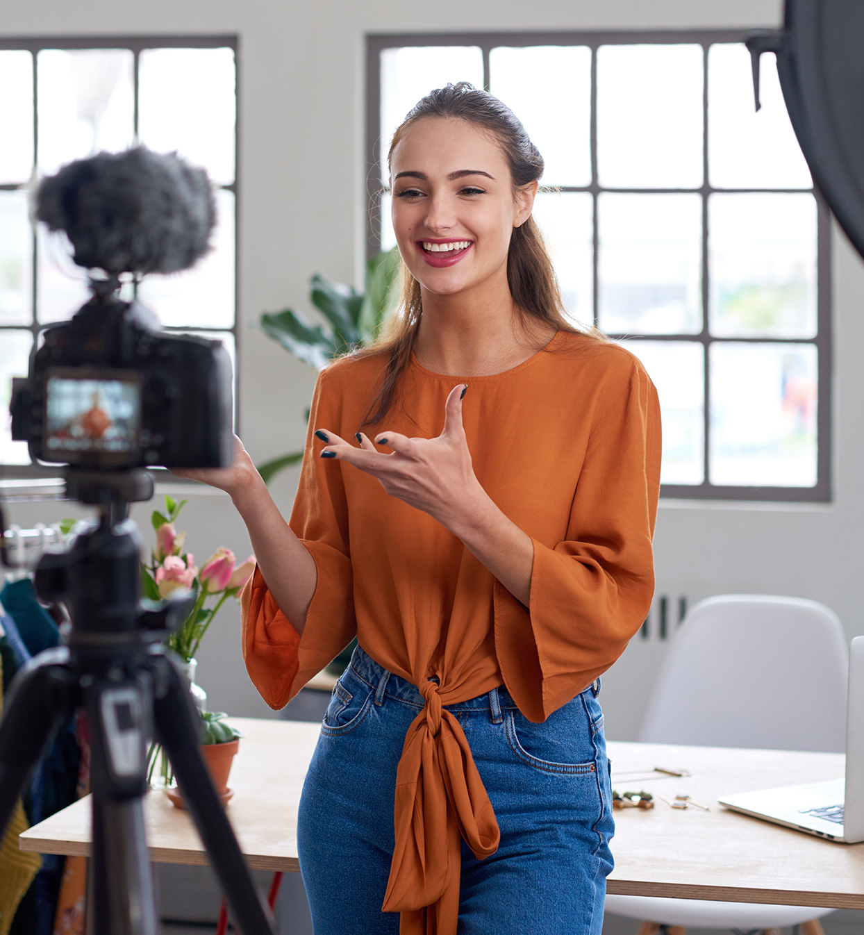 A woman talking to a camera