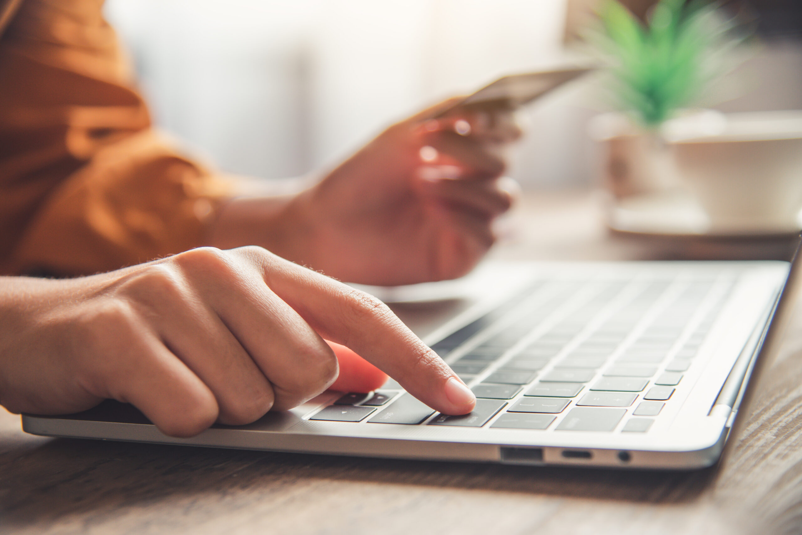 Women's hands holding a credit card and work on laptop Online payment for online shopping